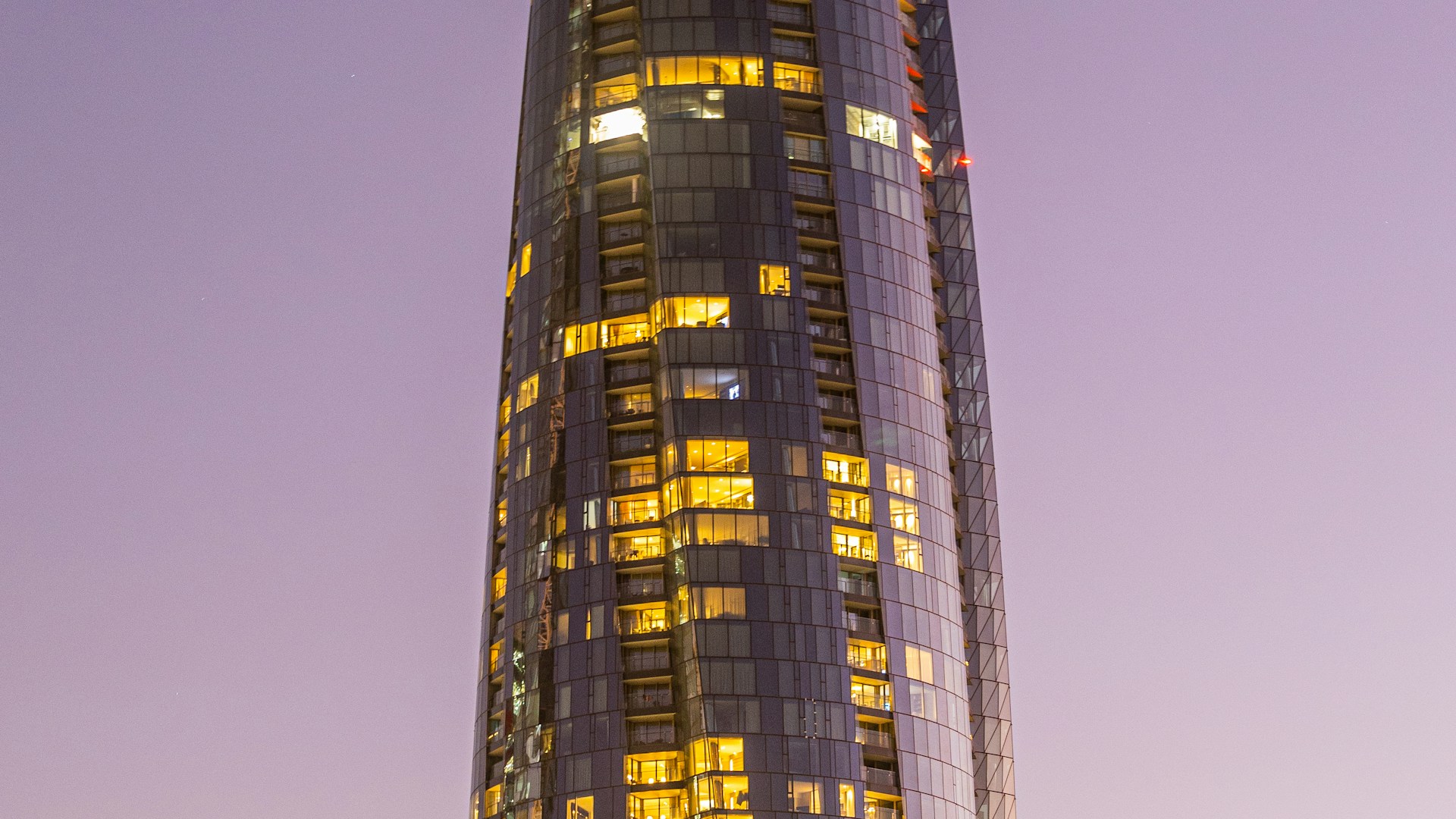 Contemporary high-rise architecture illuminated at dusk; illustrative photograph